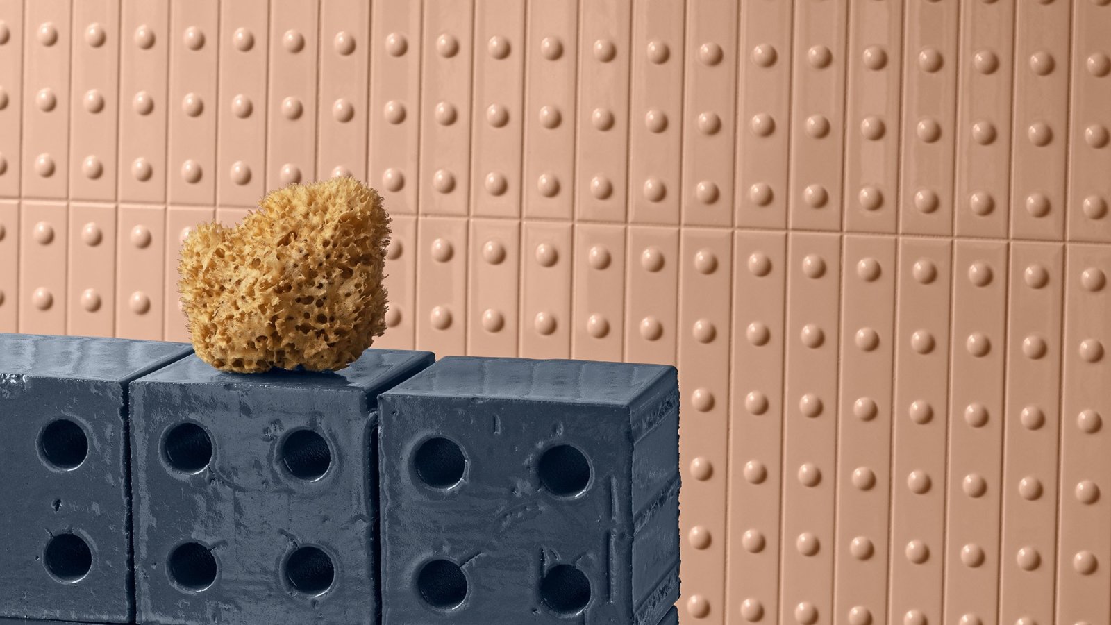 Wall clad with Punto ceramic listels by Mutina, raised-dot texture
