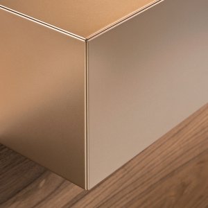 Toki reception desk with American walnut front and copper sides