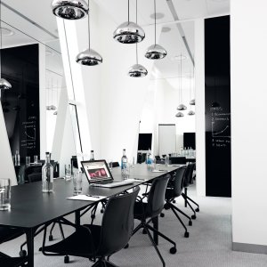Nuur tables by Arper in a row across a collaborative floor
