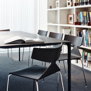 Arper Saya chair next to a solid wood table
