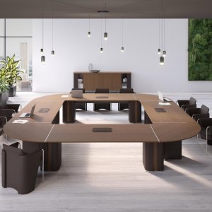 Coupè chair in perforated leather beside the AlfaOmega executive table