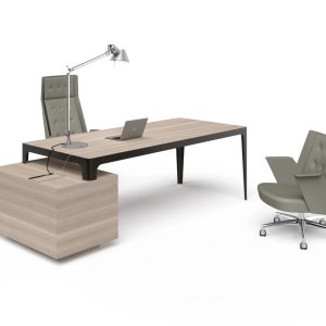 Grand More director table in light veneer resting on a service unit set at right angles