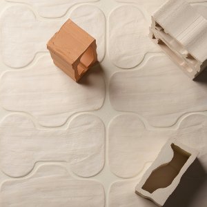 Faces & Figures tile edge showing asymmetry and cracks