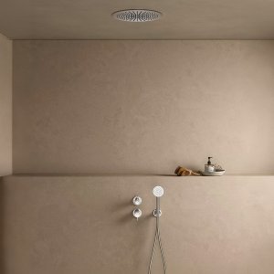 Floor-standing bath mixer of the Flora series by Fantini in a large bathroom