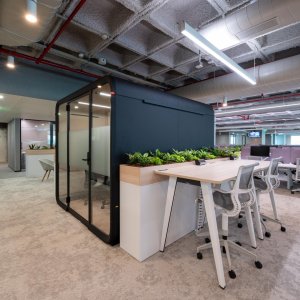 Birch table with on-table outlets in Framery Six