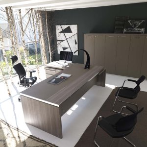 Athos executive desk by IVM in an MD cabin with guest overhang top