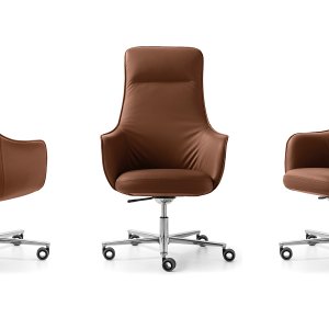 Not Guilty boss chair, high back, placed at a dark teak desk in a cabin