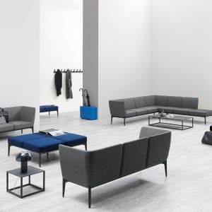 Social sofa with an armrest module in a reception area