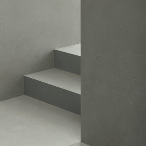 Primavera Nero flooring with Grigio wall and leather armchair