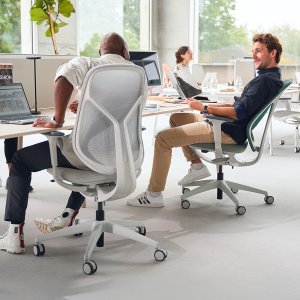 se:kit office chairs with sage upholstered medium backs around a six-seat bench