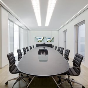 Nomos table with wood veneer top for a director cabin