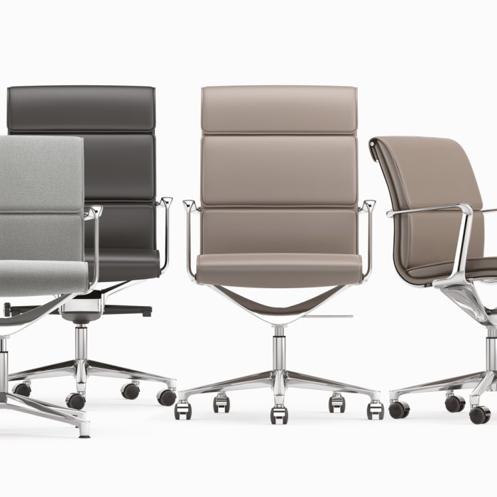 High back Italian boss chair in tan full-grain leather behind a dark wood MD table in a corporate cabin