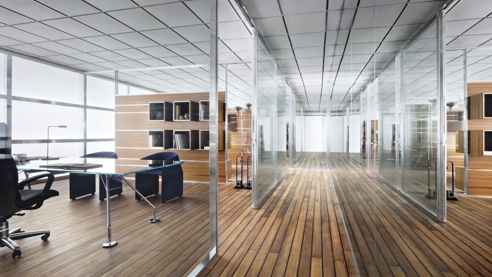 Luxurious MD cabin with an Italian executive desk and leather chair, city skyline through floor-to-ceiling windows